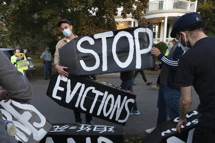 In this 2020 file photo, housing activists erect a sign in Swampscott, Mass., calling for evictions to be halted.