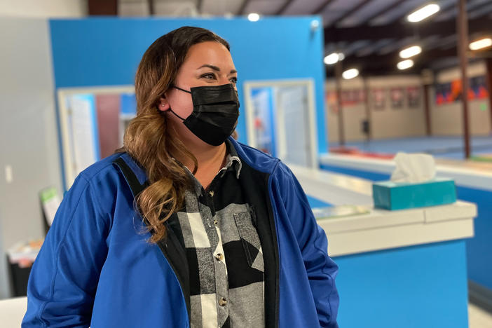 Nurse Sara Dean of Mount Juliet, Tenn., attends her daughter Harper's gymnastics practice. Dean spent nearly two years travelling the country as a nurse, gaining a much higher salary than she could at home.