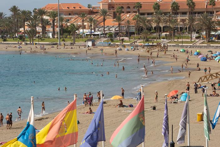 Tourists enjoy a day at the beach on the Canary Island of Tenerife. A Welsh recruitment company is treating its entire staff to a vacation on the island.