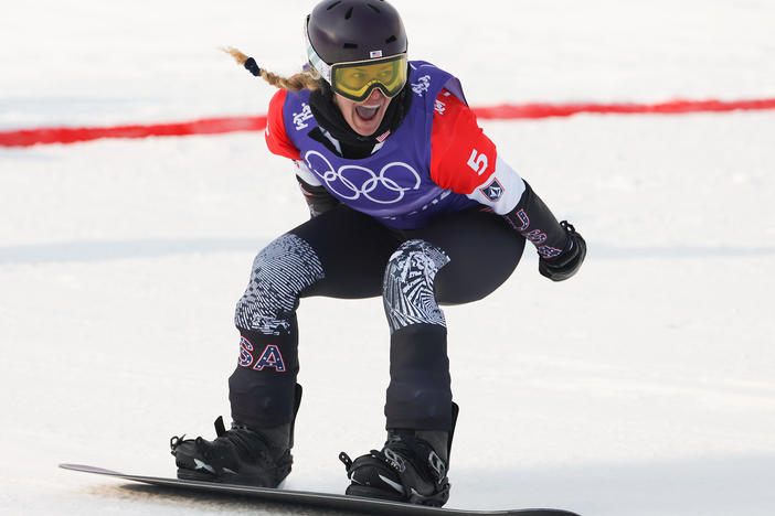 Lindsey Jacobellis celebrates after winning during the women's snowboard cross event at the Beijing Olympics. She won the U.S. its first gold medal.