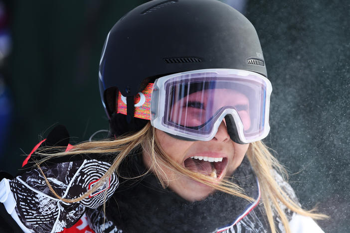 U.S. snowboarder Chloe Kim reacts after her first stellar run of the women's snowboard halfpipe final at the 2022 Winter Olympics.