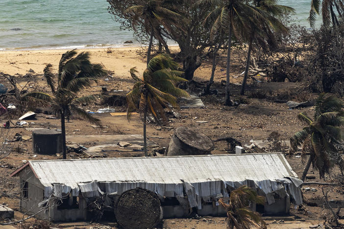 In this photo provided by the Australian Defense Force, debris from damaged buildings and trees are strewn around on Atata Island in Tonga following the eruption of an underwater volcano and subsequent tsunami.