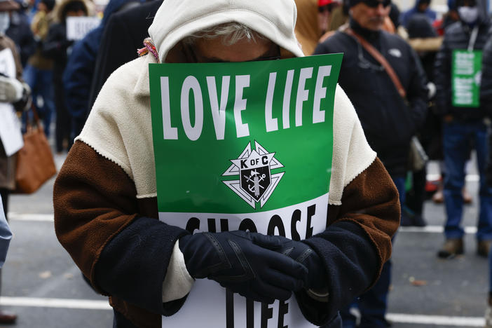 A protester prays ahead of the North Texas March for Life, celebrating the passage and court rulings upholding the Texas law known as Senate Bill 8, on Jan. 15.