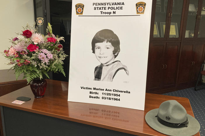 A poster of Marise Ann Chiverella is displayed with a vase of flowers and a trooper's hat at a Pennsylvania State Police news conference in Hazleton, Pa., Thursday.