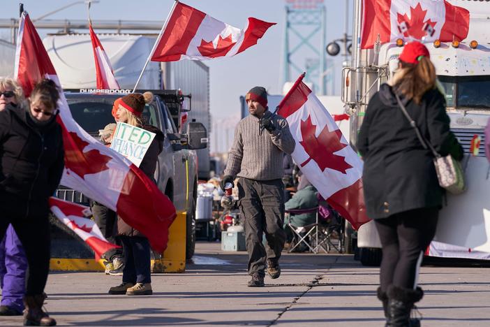 The escalating protests against COVID-19 vaccine mandates in Canada block the roadway at the Ambassador Bridge border crossing in Windsor, Ontario.