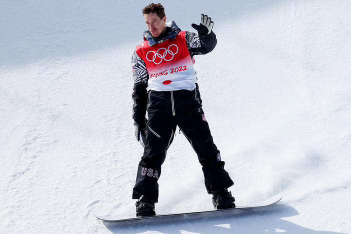 Shaun White of Team USA waves goodbye after his final run in the men's snowboard halfpipe final at the 2022 Winter Olympics in Beijing. He placed fourth in his final race.