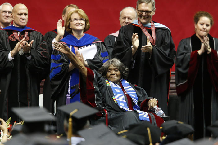 Autherine Lucy Foster (center), the first black student to attend the University of Alabama, waves as the university awarded her an honorary doctorate during a commencement ceremony, on May 3, 2019, in Tuscaloosa, Ala.