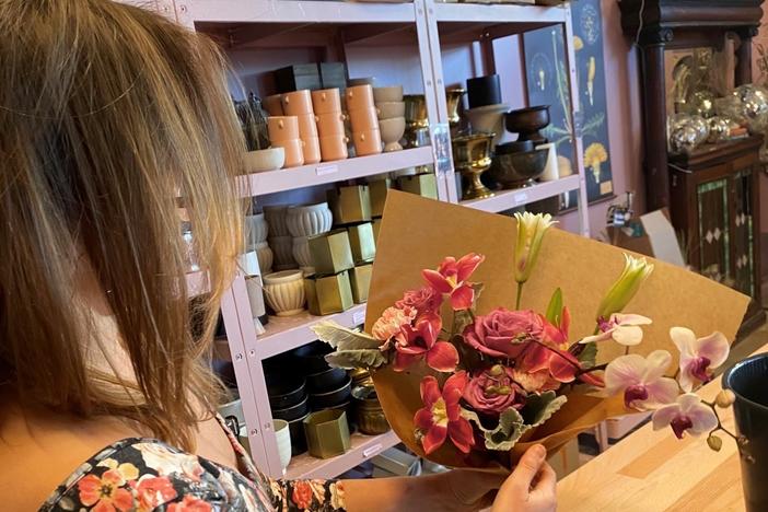 Holley Simmons, owner of the flower shop She Loves Me based in Washington, D.C., displays the grocery store-bought bouquet.