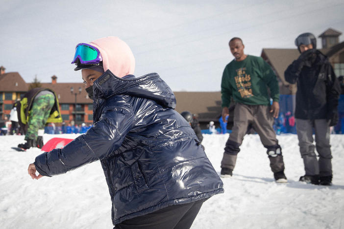 Madison Pough snowboards at Mountain Creek Resort as Diaz looks on and coaches.