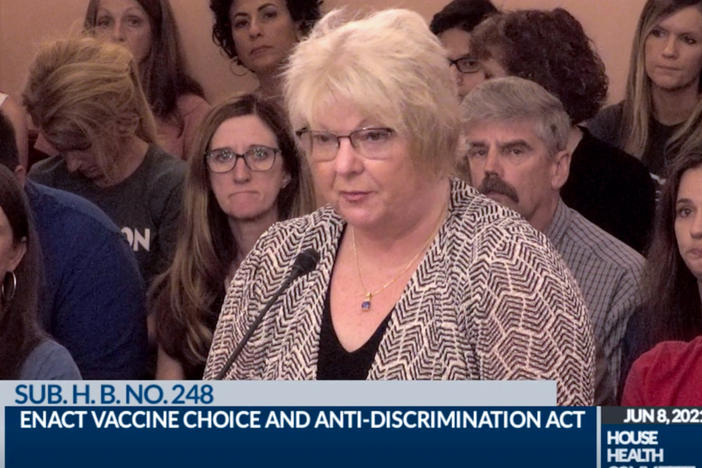 In this June 8, 2021, photo provided by the The Ohio Channel, Dr. Sherri Tenpenny speaks at a Ohio House Health Committee in Columbus, Ohio. The Cleveland-based osteopathic doctor testified that COVID-19 vaccines cause magnetism. "They can put a key on their forehead; it sticks," said Tenpenny.