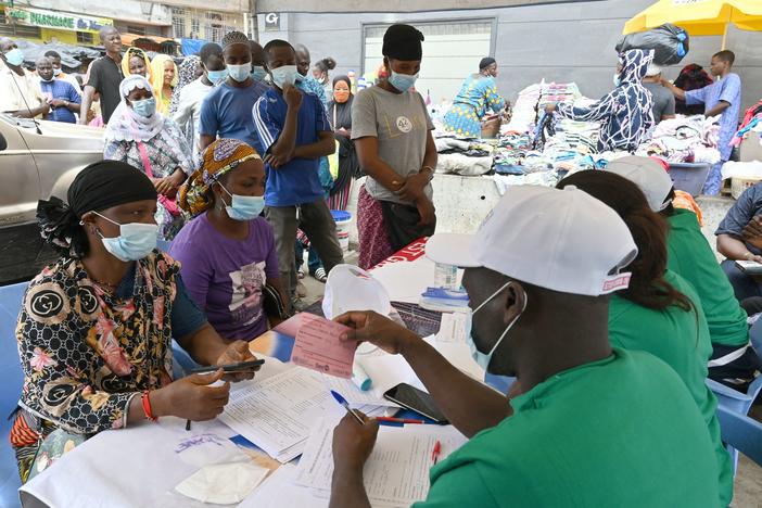 People line up to receive a Pfizer COVID-19 vaccine dose during a mass vaccination campaign in Abidjan, Ivory Coast, in August 2021.