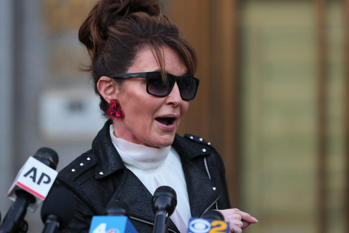 Former Republican vice presidential candidate Sarah Palin speaks with reporters as she leaves federal court on Feb. 14 in New York City.