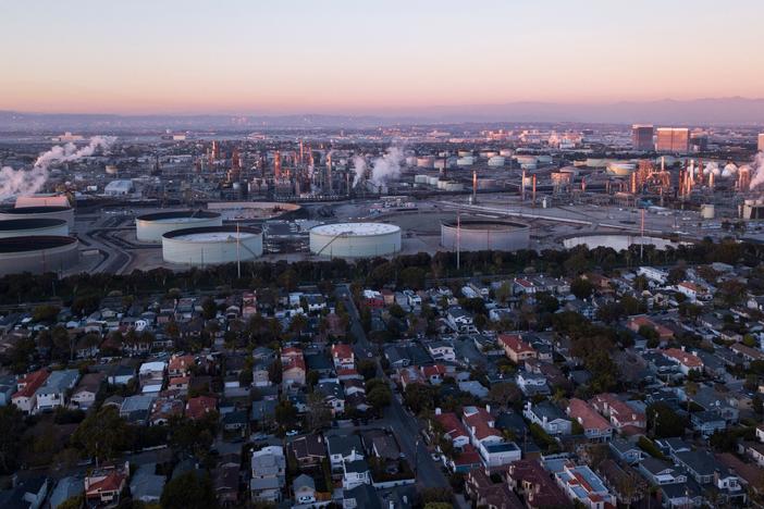 An aerial image shows storage tanks at the Chevron Products Company El Segundo Refinery adjacent to a neighborhood of homes at sunset in Manhattan Beach, Calif., on Jan. 24.