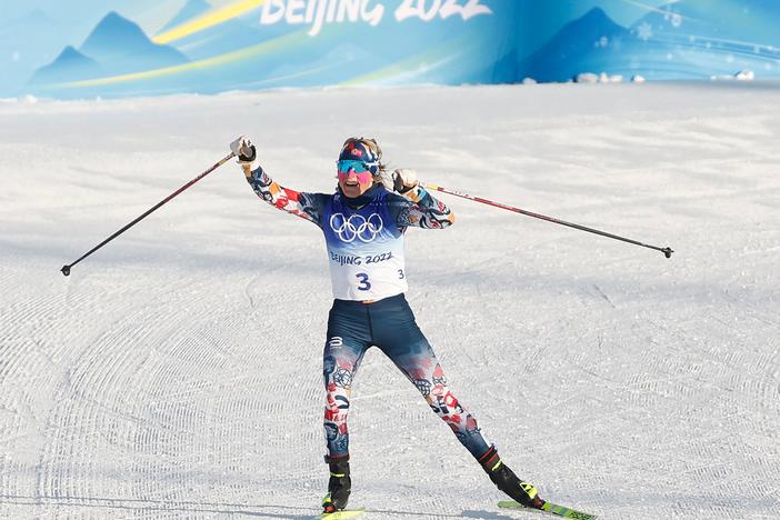 Norway's Therese Johaug gestures as she wins the women's skiathlon 2x7,5km event during the Beijing 2022 Winter Olympic Games on February 5, 2022.