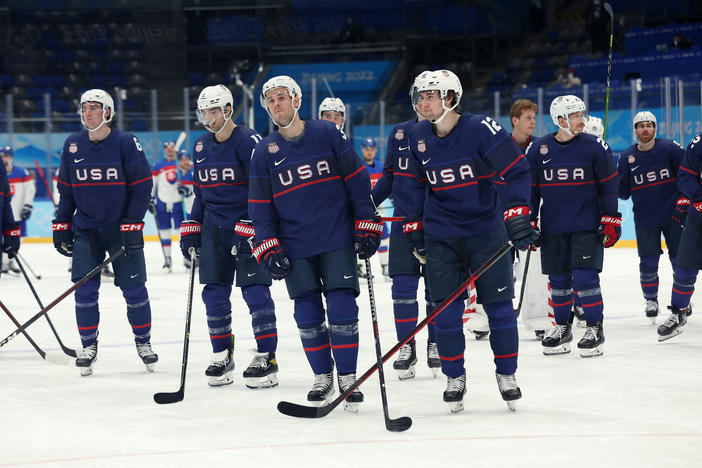 Team USA reacts after losing to team Slovakia in a penalty-shot shootout during the men's ice hockey quarterfinal match against Team Slovakia at the Beijing 2022 Winter Olympic Games.