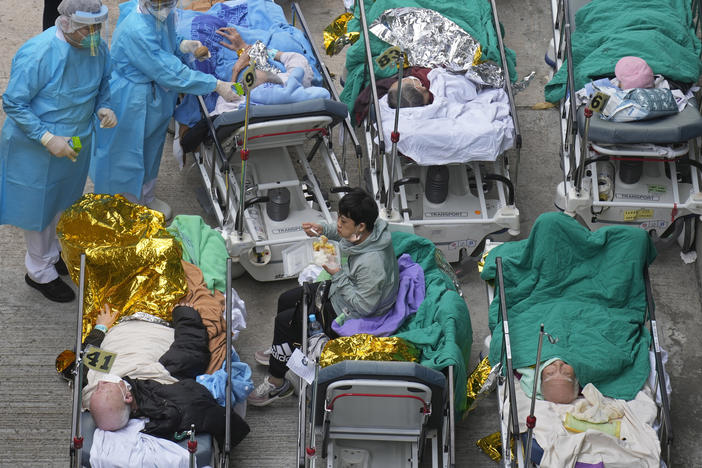 Patients are shown in hospital beds as they wait at a temporary holding area outside Caritas Medical Centre in Hong Kong on Wednesday.