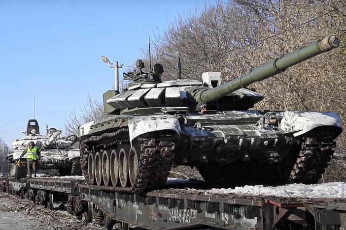 In this photo taken from video provided by the Russian Defense Ministry Press Service on Wednesday, Russian army tanks are loaded onto railway platforms to move back to their permanent base after drills in Russia.