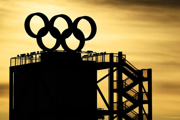 The Olympic Rings logo is seen on the top of a tower as the sun rises on Feb. 7, 2022 at the Beijing Winter Olympics.