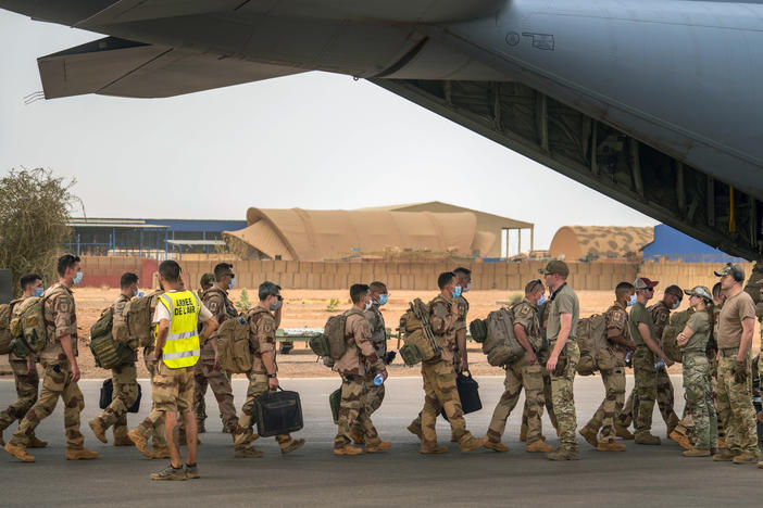 French soldiers who wrapped up a four-month tour of duty in the Sahel board a U.S. Air Force C-130 transport plane, leave their base in Gao, Mali on Wednesday, June 9, 2021.
