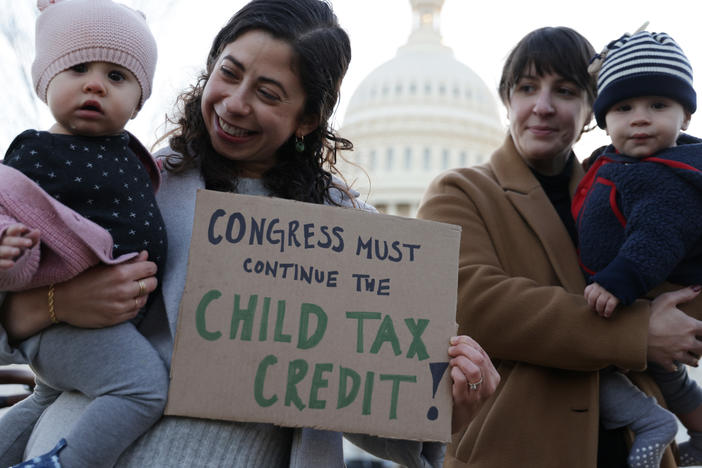 Local residents, Cara Baldari and her nine-month-old daughter Evie (L) and Sarah Orrin-Vipond and her eight-month-old son Otto (R), join a rally in front of the U.S. Capitol December 13, 2021 in Washington, DC. The monthly Child Tax Credit payments expired at the end of last year after Congress failed to renew it.