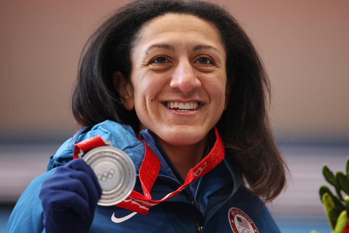 Elana Meyers Taylor says it's "humbling" to carry the flag for Team USA, after not being able to be the flag bearer for the opening ceremony. She's seen here posing with her silver medal from the women's monobob competition. The Beijing Olympics' closing ceremony takes place on Sunday.