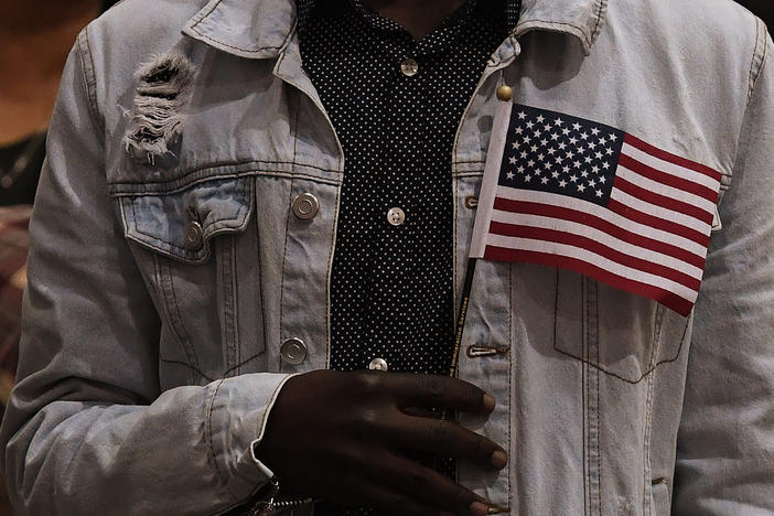 People pledge allegiance to America as they receive U.S. citizenship at a naturalization ceremony for immigrants in Los Angeles in 2017.