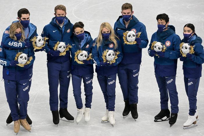 Team USA's silver medalists pose during the flower ceremony of the figure skating team event last week. They had asked to have the medal ceremony before they leave Beijing.