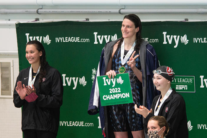 Lia Thomas, center, smiles on the podium after winning the 200-yard freestyle during the 2022 Ivy League Women's Swimming and Diving Championships on Friday.