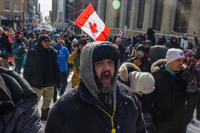 People participate in a protest organized by truck drivers opposing vaccine mandates on Wellington St. on Saturday in Ottawa, Ontario.