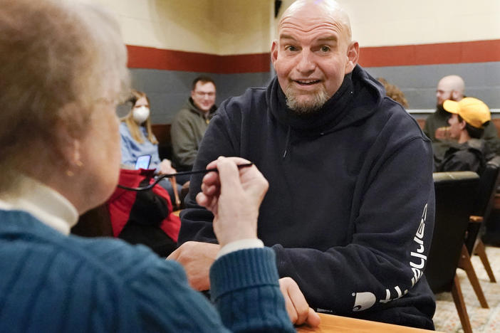 Pennsylvania Lt. Gov. John Fetterman, who's considered the early front-runner in the Democratic primary for the state's open U.S. Senate seat, talks with a voter during a campaign stop at the Mechanistic Brewery, in Clarion, Pa., on Feb. 12.