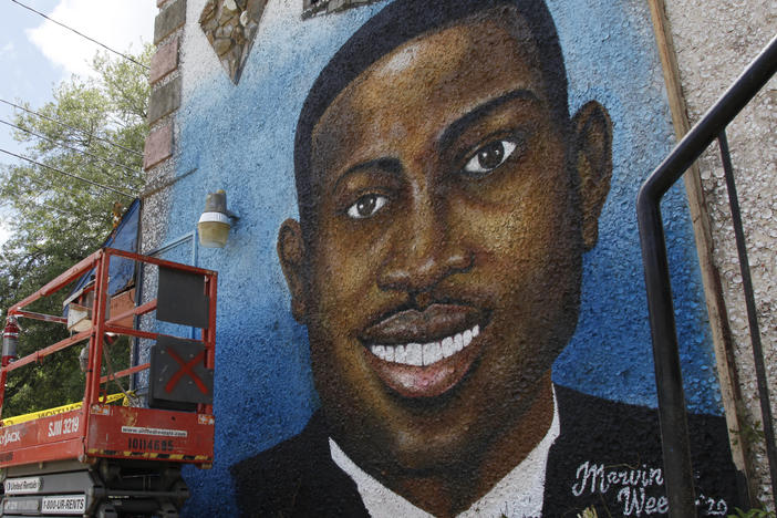 This May 17, 2020, file photo, shows a mural depicting Ahmaud Arbery in Brunswick, Ga.