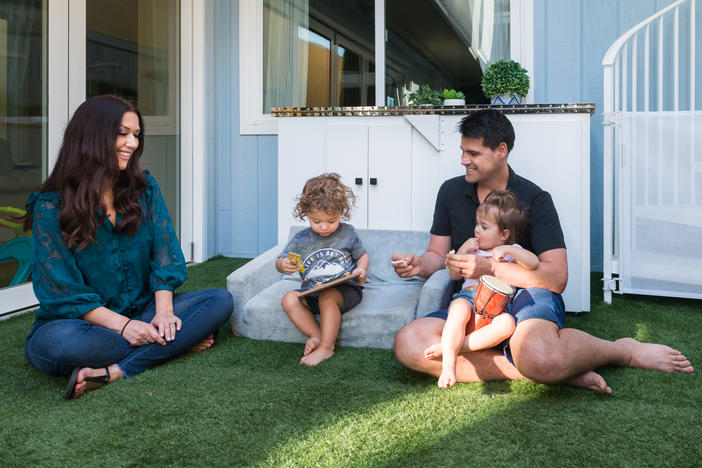 Sugar and Greg Bull play with their twins, Redford and Scarlett, who were born prematurely in 2020. Their insurance company initially said the births were not an emergency, and the family ended up with bills totaling more than $80,000.