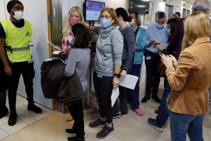 Staff volunteers queue to receive a fourth dose of the Pfizer COVID-19 vaccine at Sheba Medical Center in Israel on Dec. 27, 2021, as the hospital conducted a trial of a fourth jab of the vaccine.