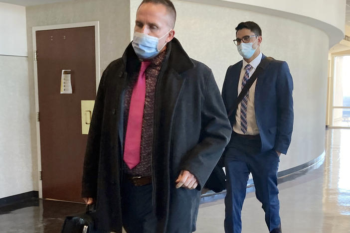 Brett Hankison (left) exits the courtroom after the first day of jury selection in his trial on Feb. 8, in Louisville, Ky. Hankison is on trial for allegedly firing shots into the apartment next door to Breonna Taylor's the night she was killed.