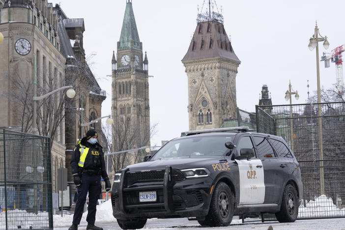 A police officer mans a checkpoint near Parliament Hill on Wednesday in Ottawa. Ottawa protesters who vowed never to give up are largely gone, chased away by police in riot gear in what was the biggest police operation in the nation's history.