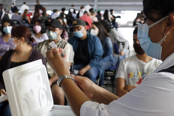 A health worker in Mexico City prepares a Sputnik V dose during a mass vaccination effort against COVID-19. A new study in Mexico shows that non-mRNA vaccines like the Russian version can be as effective as mRNA vaccines like Pfizer if the patient has previously been infected with SARS-CoV-2.