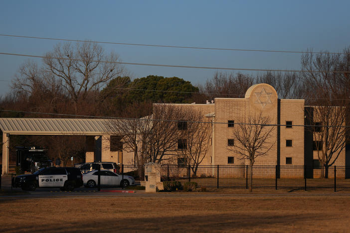 A police vehicle sits in front of Congregation Beth Israel in Colleyville, Texas, on Jan. 16, the day after a gunman took worshippers hostage at the synagogue. Colleyville is among dozens of U.S. cities dealing with the distribution of antisemitic flyers in recent weeks.