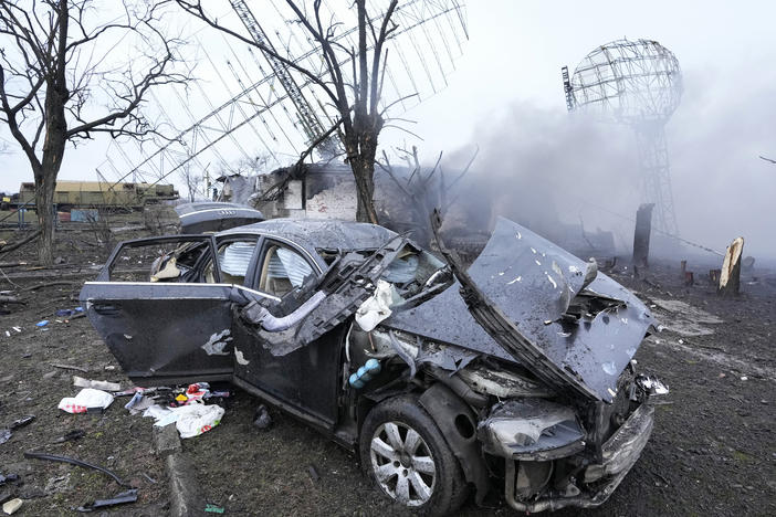 Damaged radar, a vehicle and equipment are seen at a Ukrainian military facility outside Mariupol.