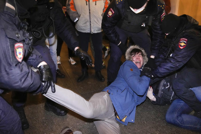 Police officers detain demonstrators in St. Petersburg, Russia, Thursday. Hundreds of people gathered in Moscow and St.Petersburg to protest against Russia's attack on Ukraine.