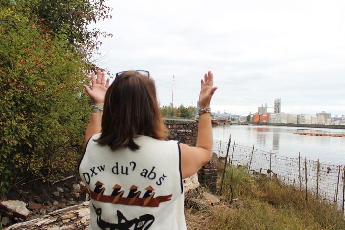 Duwamish Tribal Services Executive Director Jolene Haas holds up her hands, a traditional gesture of gratitude, on the banks of the Duwamish River in Seattle on Sept. 21, 2019.