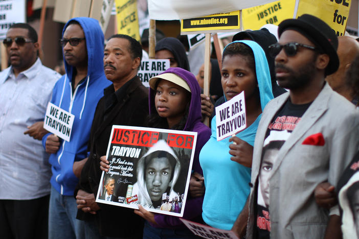 People in Los Angeles walk in a silent protest march on April 9, 2012, to demand justice for the killing of Trayvon Martin.