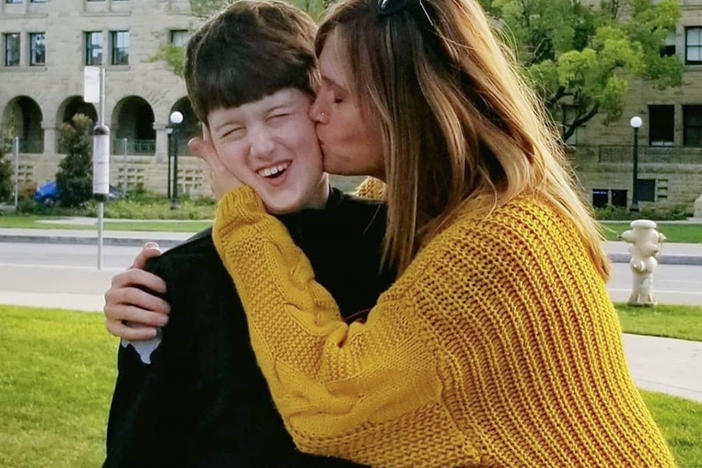Texas resident Amber Briggle kisses her son. She says the onslaught of anti-trans legislation in the state is emotionally traumatizing.