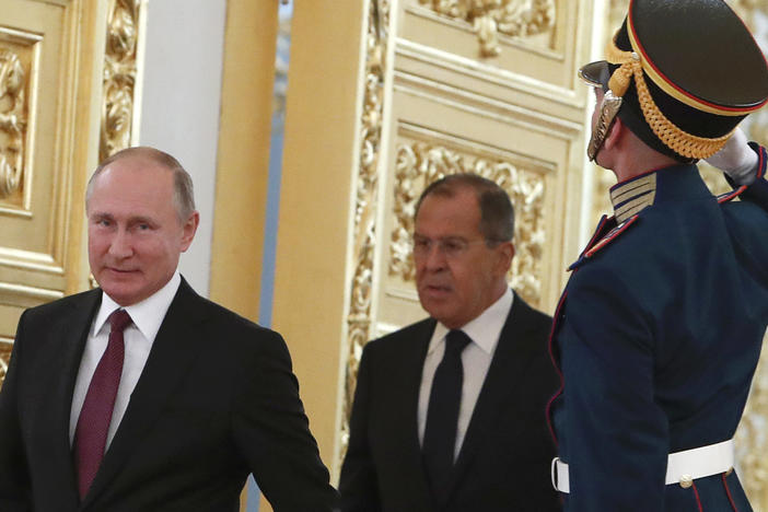 Russian President Vladimir Putin and Foreign Minister Sergei Lavrov walk past honour guards at the Kremlin in Moscow. U.S. sanctions are targeting Putin and a handful of individuals believed to be among his closest advisors.