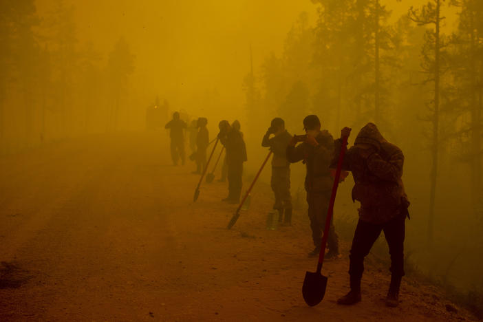 Volunteer firefighters rest west of Yakutsk, Russia, in August 2021. Wildfires are getting more common in Siberia, undercutting the ability of the region's vast forests to absorb carbon dioxide from the atmosphere.