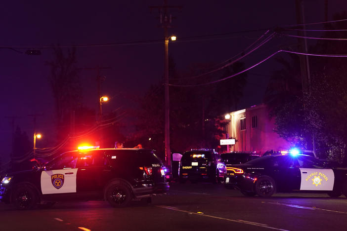 Law enforcement vehicles from several agencies block a street near the scene of a shooting in Sacramento, Calif., on Monday.