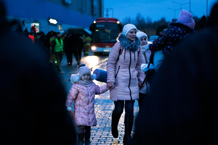 People arrive in Poland who have just crossed the border by bus from Ukraine at the Korczowa-Krakovets crossing.