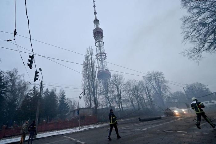 A fireman runs Tuesday after Russian airstrike hit Kyiv's main television tower in Kyiv in the heart of the Ukrainian capital.