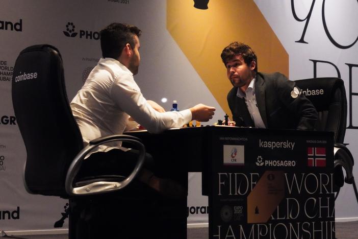 Ian Nepomniachtchi of Russia (left) and Magnus Carlsen of Norway talk after Carlsen won the FIDE World Championship in 2021. FIDE has banned competitions in Russia and Belarus in response to Russia's invasion of Ukraine.