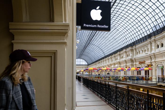 A woman passes by an Apple store at the GUM department store in central Moscow on April 27, 2021. Apple said this week that it's pausing the sale of its products in Russia.