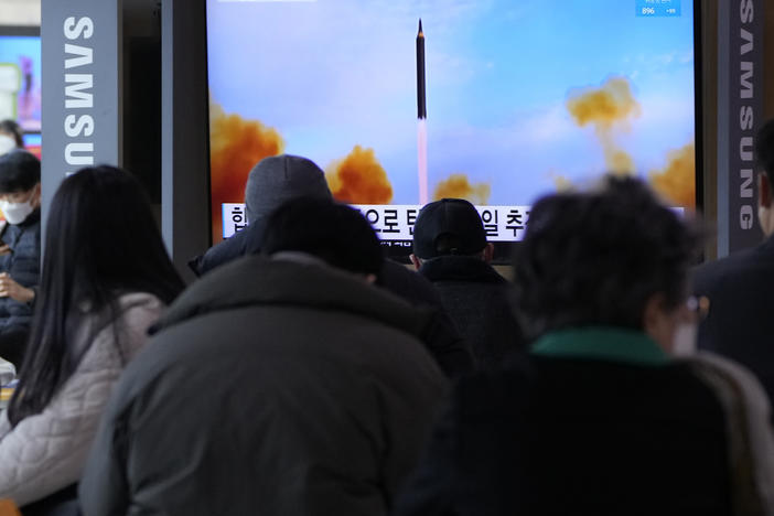 People watch a TV showing a file image of North Korea's missile launch during a news program at the Seoul Railway Station in Seoul, South Korea, on Saturday, March 5, 2022. North Korea on Saturday fired a suspected ballistic missile into the sea, apparently extending its streak of weapons tests this year amid a prolonged freeze in nuclear negotiations with the United States.